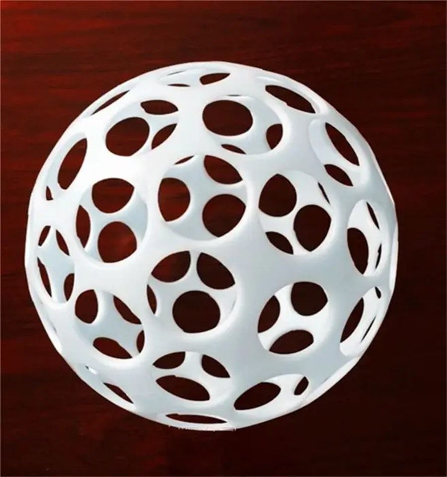ABS flocculation ball on a dark wooden surface