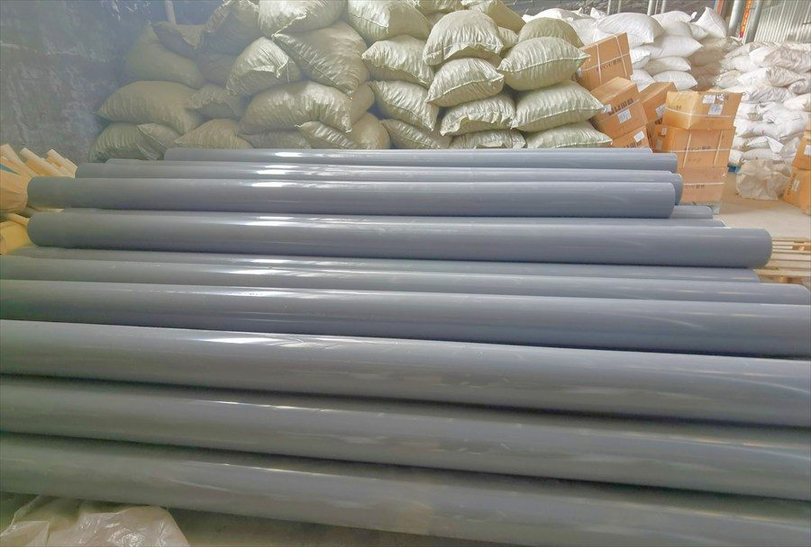 Grey ABS pipe stacked in the warehouse