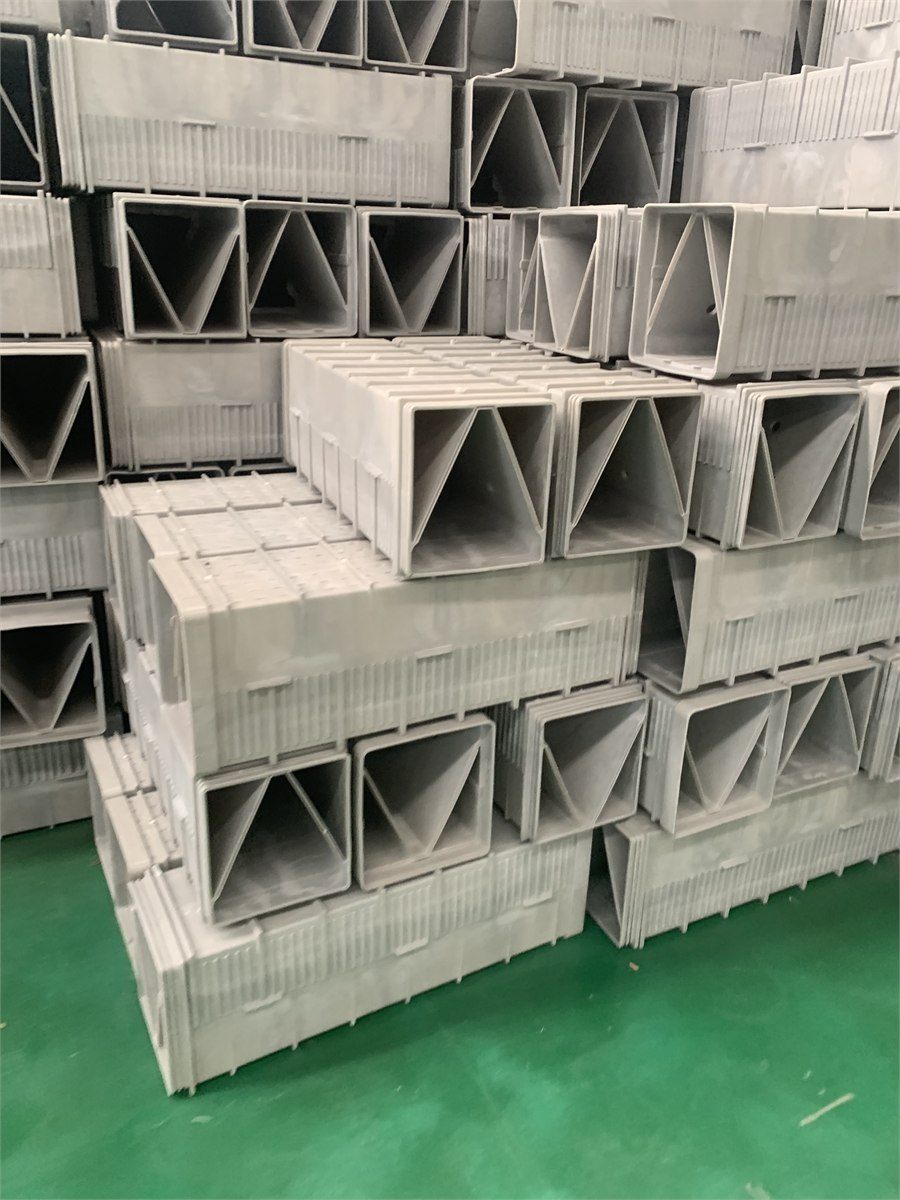 Stacks of grey filter bricks on the factory floor