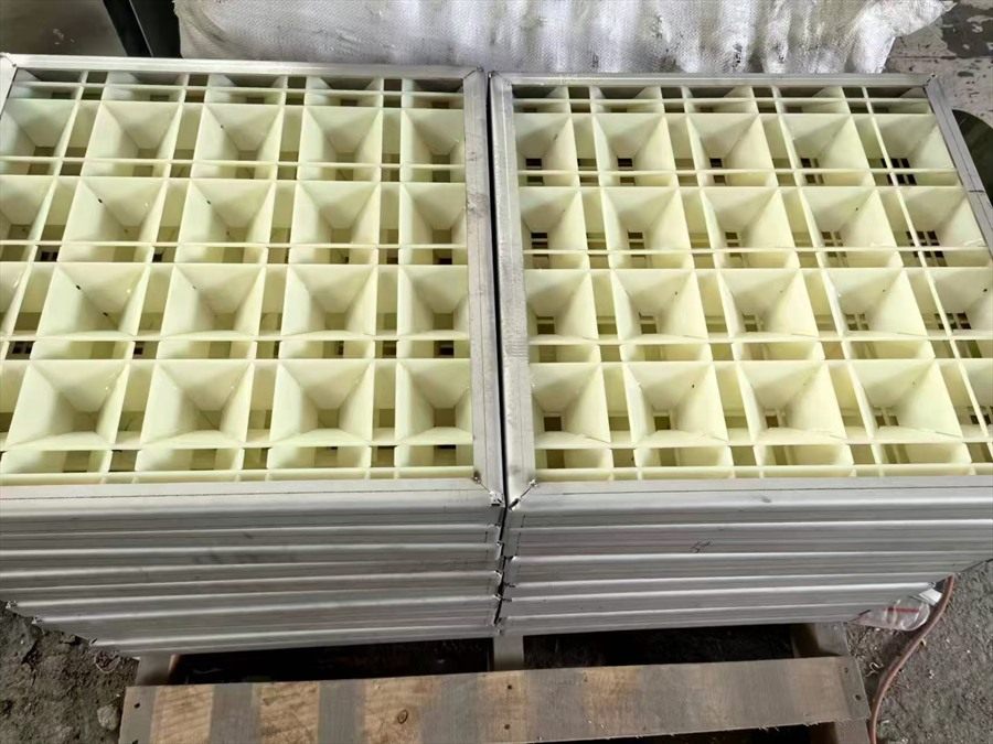 Two flocculation grid modules stacked on a workshop floor