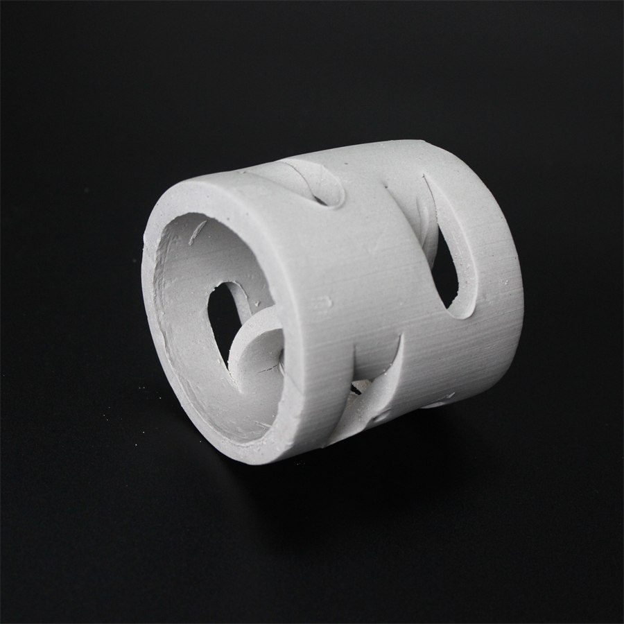White Pall ring, single piece, showing the punched tongue windows on a dark background