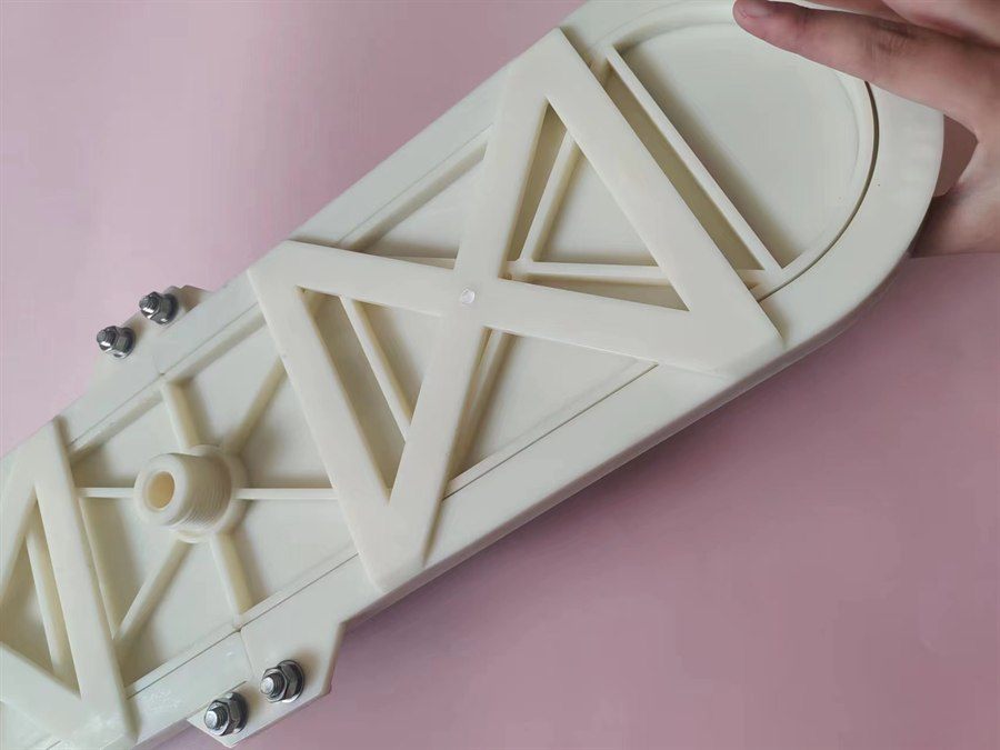 Rear of the plate aerator held in hand, showing the air inlet hub