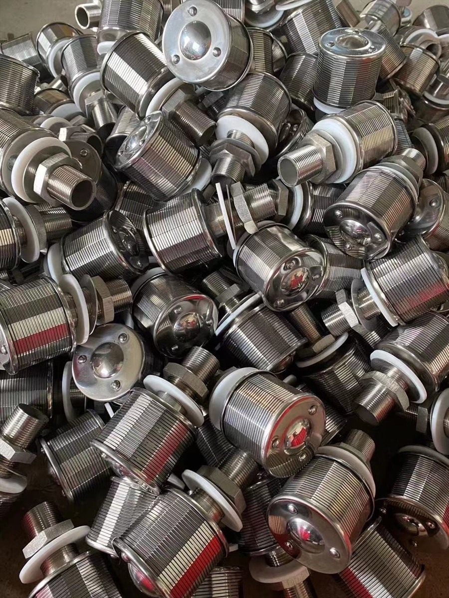 Close-up of drain caps with white sealing washers fitted at the flange joint