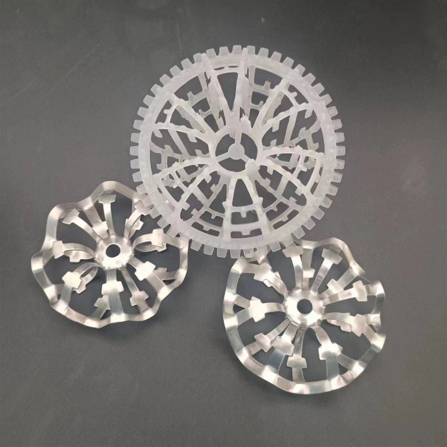 Plastic rosette ring beside two stainless steel rosette rings on a dark grey background
